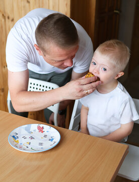 The family is spending time at home with a child with Down syndrome.