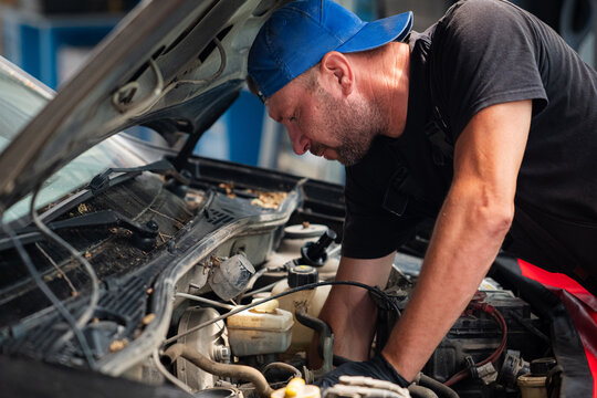 Mechanic Working Under Hood