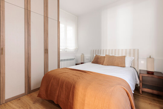 Minimalist bedroom with terracotta blanket