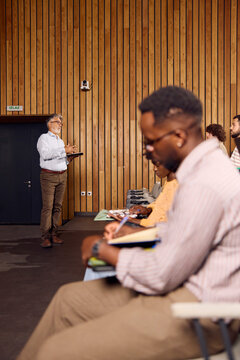 Man Giving a Presentation to a Small Audience 