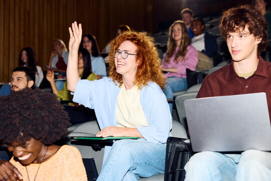 Excited student asks questions during a lecture.