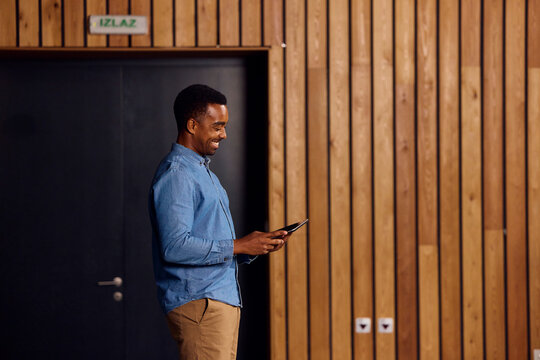 Smiling man is addressing the class in the lecture room.