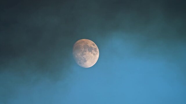 View of the moon as wildfire smoke moves past it from the Tom Creek fire in the Utah desert.