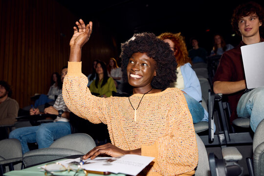 Excited student raises her hand to ask a question