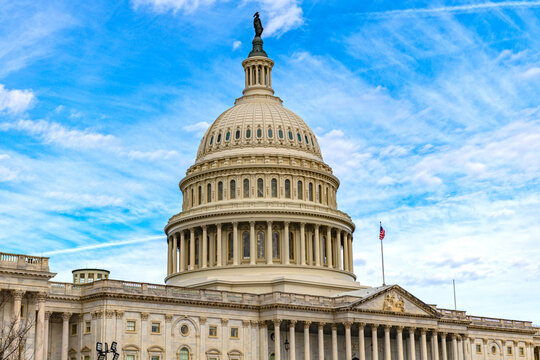 Capitol skyline monument in Washington DC blue sky. Patriotic exterior building in Washington DC clouds. Washington government Congress Senate legislation Washington. Historic national icon.