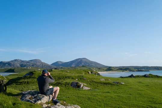 Man enjoying the view overlooking Uig Sands, Isle of Lewis.