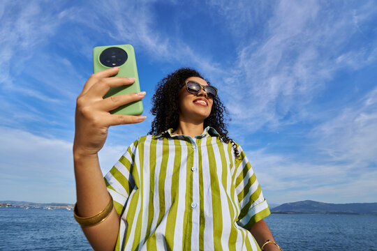 Young woman taking selfie while enjoying summer vacation