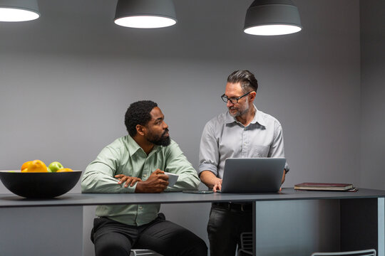 Business Colleagues Conversing Over Laptop in the Late Hours