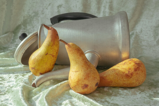 Fruit and metal kitchen tools are arranged on a soft surface