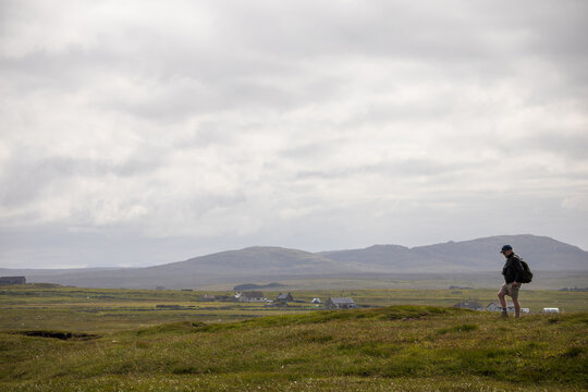 Hiker walking across The Lewis Peatlands on the Isle of Lewis