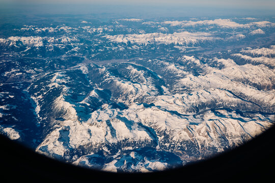 View of snowy mountains from airplane
