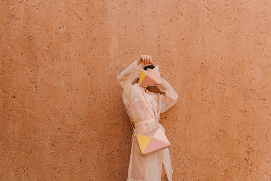 Pastel Fashion With Geometric Handbag Against Wall
