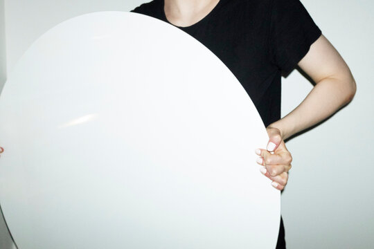 Person holding geometry rounded shape sign with empty space for text
