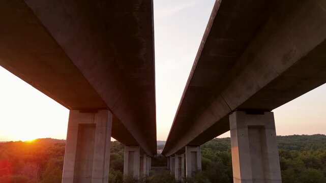 Concrete highway bridge pillars at golden hour sunset