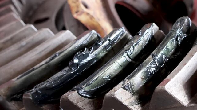 panning shot Of Differential Crown Gear Teeth Coated With Lubricating Grease.