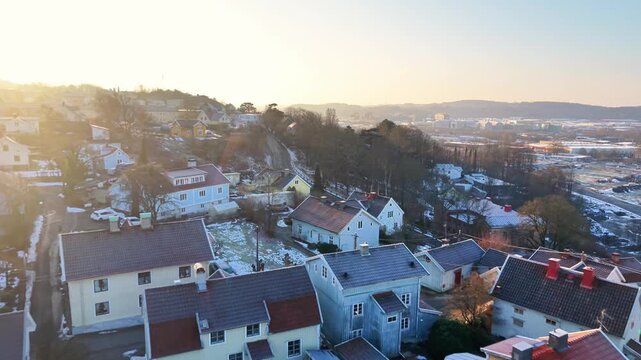 Aerial view of historic Molndals Kvarnby with colorful houses and snow-covered rooftops in the winter light in Molndal, Vastra Gotalands lan, Sweden.