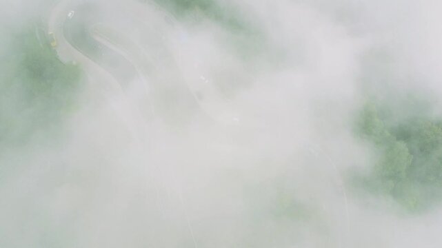 Aerial view of Panatapan Berastagi obscured by dense fog and clouds in Berastagi, North Sumatra, Indonesia.