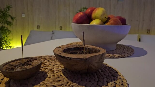 Enjoying a traditional drink while tasting fresh fruits at home in the evening