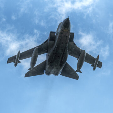 Corridonia, Italy - 10 May 2024: View of an Italian Air Force Panavia Tornado fighter jet flying against a clear blue sky.