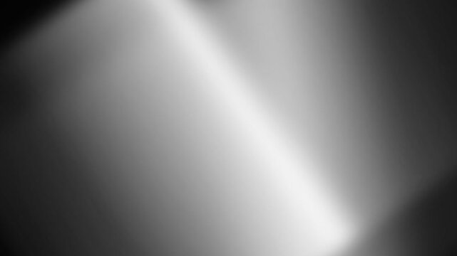 Abstract background featuring a soft diagonal beam of light on gray texture
