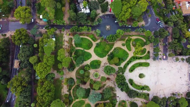 Aerial view of Terrazza del Pincio featuring lush green trees, winding pathways, and formal garden layouts in the historic urban park of Roma, Lazio, Italy.