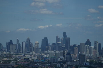 Fototapeta premium A panoramic cityscape of high rise towers packed with skyscrapers and office towers over the capital of Thailand in Southeast Asia, a clean modern wide angle composition.