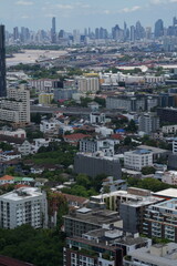 A panoramic cityscape of high rise towers spreading across the metropolitan skyline over the capital of Thailand in Southeast Asia, ideal for travel and business themes. © ultramansk