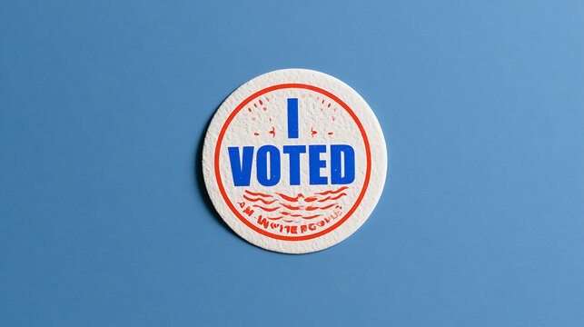 A round paper sticker with the text I voted on a clean blue background symbolizing civic duty democracy and national election day concept