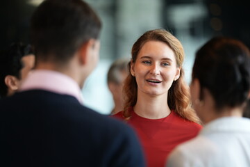 Obraz premium Business people at a rooftop reception, enjoying conversation at the hotel party at a bright hotel reception by the windows, in a stylish contemporary hospitality setting.