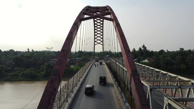 Aerial view of the Wampu River Bridge Binjai - Langsa Toll Road with traffic crossing the river in Stabat, North Sumatra, Indonesia.