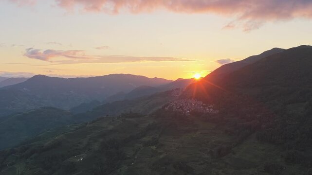 Aerial view of sunrise over the terraced mountains in Honghe Hani and Yi Autonomous Prefecture, Yunnan, China.