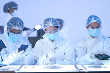 A research professional stands with arms crossed facing the camera against a modern lab backdrop...