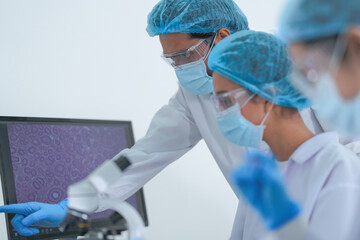 A research scientist raises a sample toward the light to check clarity in a clean modern science...