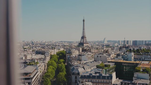 Camera movement pushing forward through safety railing bars to reveal a sweeping panoramic view of the Eiffel Tower and Paris skyline from Arc de Triomphe. High quality 4K B-roll video.
