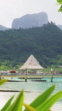 Bora Bora Travel vacation luxury resort hotel overwater bungalows on paradise beach. Romantic holidays destination on Bora Bora, Tahiti, French Polynesia. Raw vertical video.
