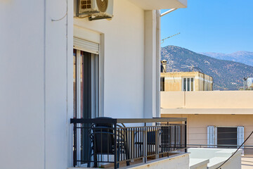 Modern apartment balcony with mountain view on a sunny day