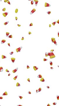 Colorful candy corn falling on white background vertical video