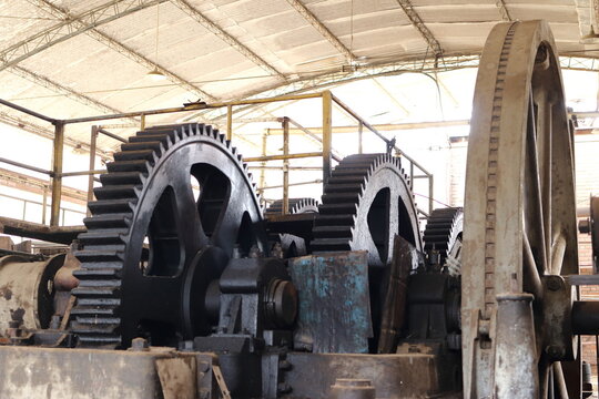Heavy industrial gears and wheels inside an old mill