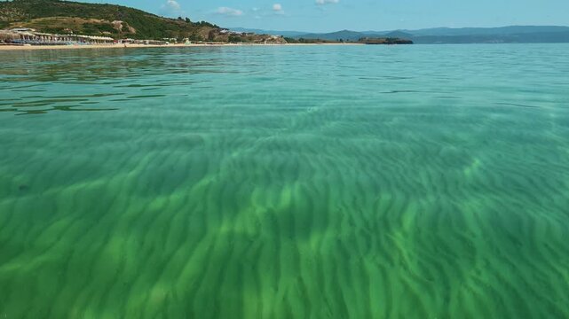 Clear water ripples gently under sunlight. Trani Ammouda, Greece
