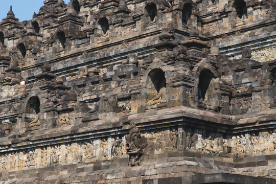 Ancient Stone Relief Carvings and Buddha Statues in Niches on the Multi-Tiered Terraces of Borobudur Temple in Central Java Indonesia