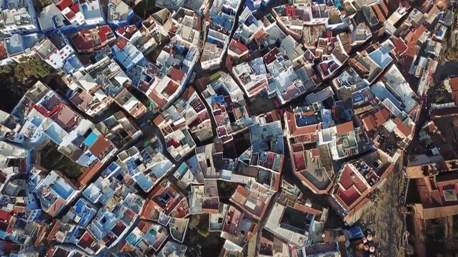 Aerial view of the historic blue-painted buildings and terracotta rooftops of the medina in Chefchaouen, Tangier-Tetouan-Al Hoceima, Morocco.