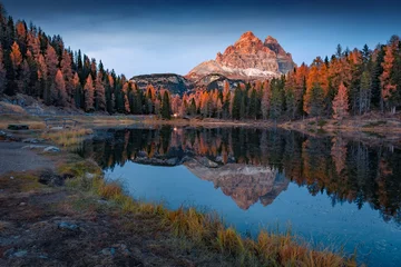 Majestic autumn scene of Antorno lake with Tre Cime Di Lavaredo peak on background. Wonderful evening scene of Dolomite Alps, blue hours picture, Italy, Europe. Beauty of nature concept background. © Andrew Mayovskyy