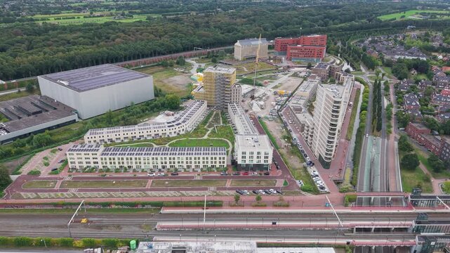 Aerial view of industrial area and modern residential complex between highway a28 and train station amersfoort vathorst in the netherlands