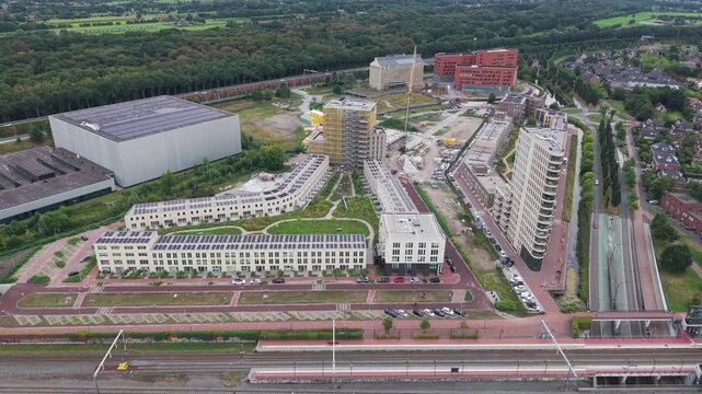 Aerial view of industrial area and modern residential complex between highway a28 and train station amersfoort vathorst in the netherlands
