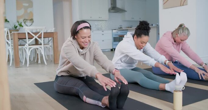 Diverse female friends warming up with seated stretch in home workout on black mats