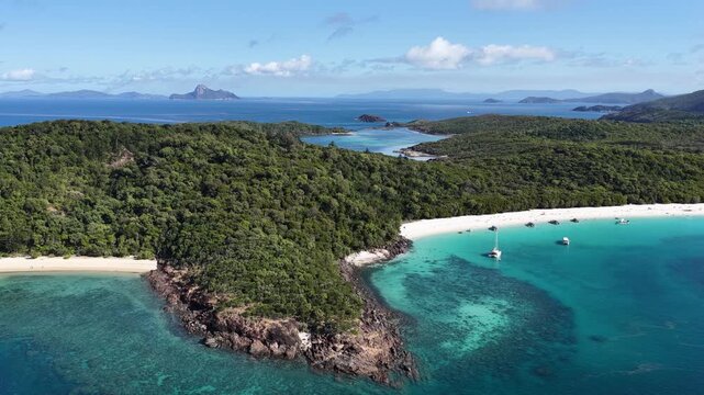 Aerial view of Whitehaven Beach with turquoise water, white silica sand, and boats anchored, Whitsunday Islands, Queensland, Australia.