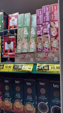ITABIRA, MINAS GERAIS, BRAZIL - SEPTEMBER 03, 2026: Nescafe Farmers Origins and Tres Coracoes coffee capsule sleeves displayed on supermarket shelves for sale with price tags.