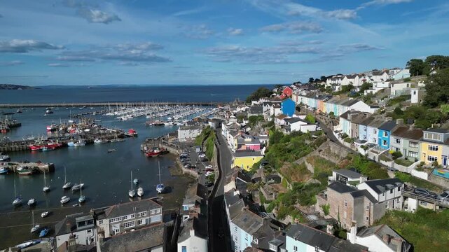 Brixham, Devon, England: DRONE VIEWS: 1. The residential district of the town of Brixham; 2. The inner and outer harbour with moored trawlers and yachts. Brixham is the UK's leading fishing port.