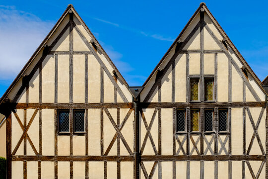 Timber-framed gable houses against a blue sky