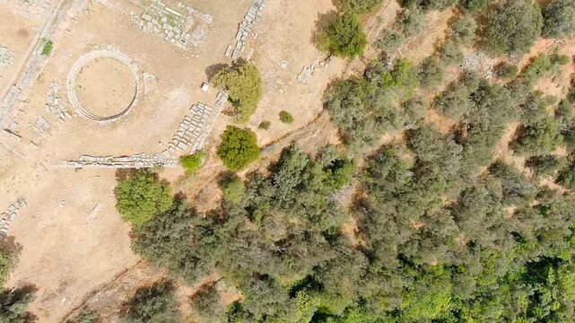 Delphi, Greece. Ruins of the ancient city of Delphi. Sunny weather, Summer. Drone footage, HEAD OVER SHOT